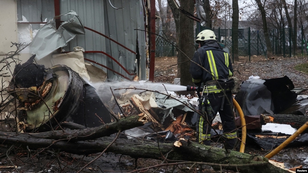 A firefighter extinguishes the remains of an unidentified missile that Kyiv claims was made in North Korea at the site of a Russian strike in Kharkiv on January 2.