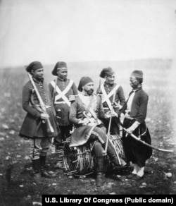 Gyorgy Kmety (seated), a Hungarian who rose through the ranks of the Ottoman Army under the name Ismail Pasha. The general is photographed with three soldiers and a servant.