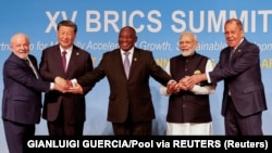 (Left to right) Brazilian President Luiz Inacio Lula da Silva, Chinese President Xi Jinping, South African President Cyril Ramaphosa, Indian Prime Minister Narendra Modi, and Russian Foreign Minister Sergei Lavrov pose for a family photo during the BRICS summit in Johannesburg, South Africa, on August 23. 
