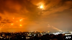 Rockets fired by Palestinian militants from Gaza City are intercepted by the Israeli Iron Dome defense system in the early hours of October 8.