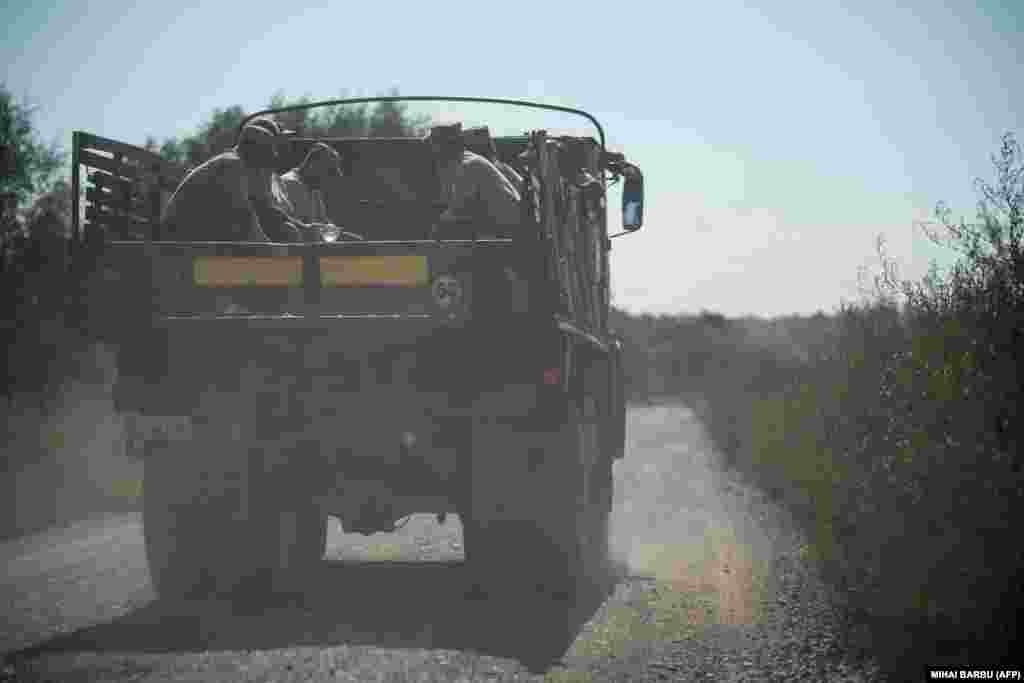 Romanian soldiers ride atop a truck after building the bomb shelters. Since Moscow's unprovoked full-scale invasion of Ukraine in February 2022, NATO has been focused on preventing the war from spilling over onto its territory.