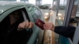 A Serbian traveler prepares his passport for control at the border with Hungary and Serbia in Horgos on December 19, 2009.