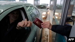 A Serbian traveler prepares his passport for control at the border with Hungary and Serbia in Horgos on December 19, 2009.