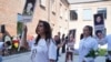 Local residents marched on September 1 in the yard of School No. 1 in Beslan, holding portraits of loved ones they lost 20 years ago in the massacre.