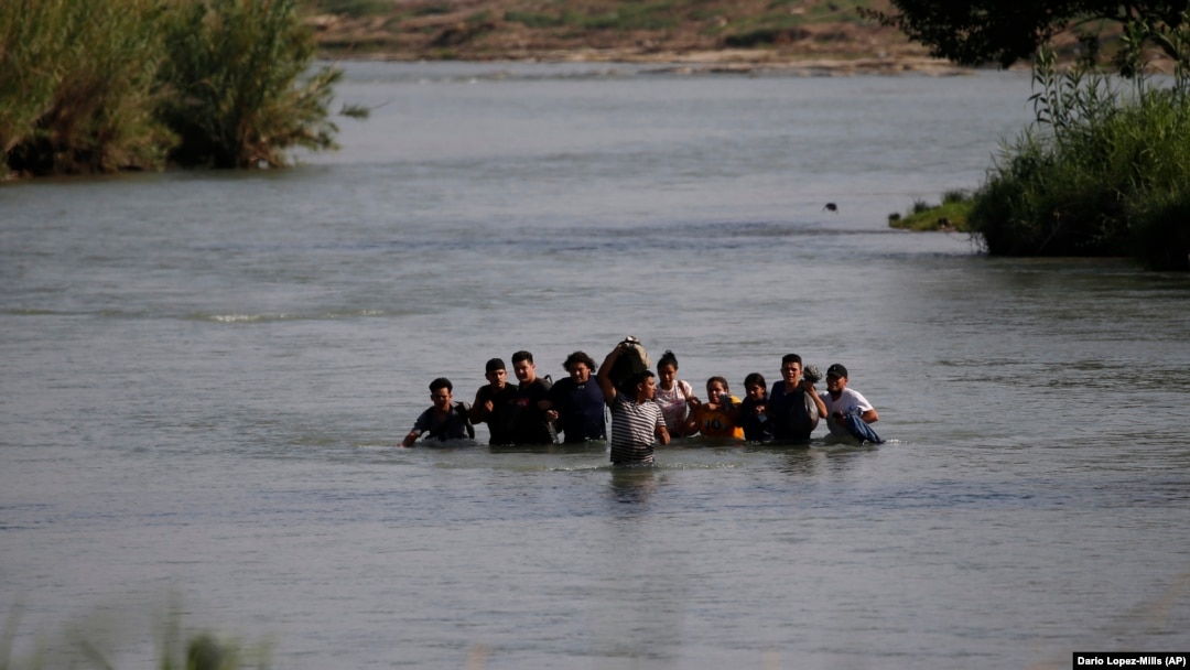 Migrants cross the Rio Grande river into the United States at Eagle Pass, Texas, in May.