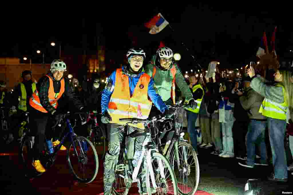 Serbian student cyclists celebrate as they arrive at a stopover during a bike ride to Strasbourg, France. Their trip aims to raise awareness within European Union institutions about ongoing anti-government protests in Serbia.