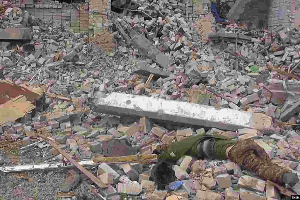 The body of a dead Ukrainian fighter lies amid rubble at an unnamed location in a picture released on April 27. 