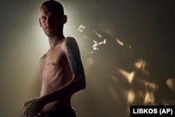 Dmytro Kozatskiy, head of the Azov Brigade' press service, photographer and Mariupol defender, shows his emaciated body after being held in Russian captivity and released in a prisoner exchange.