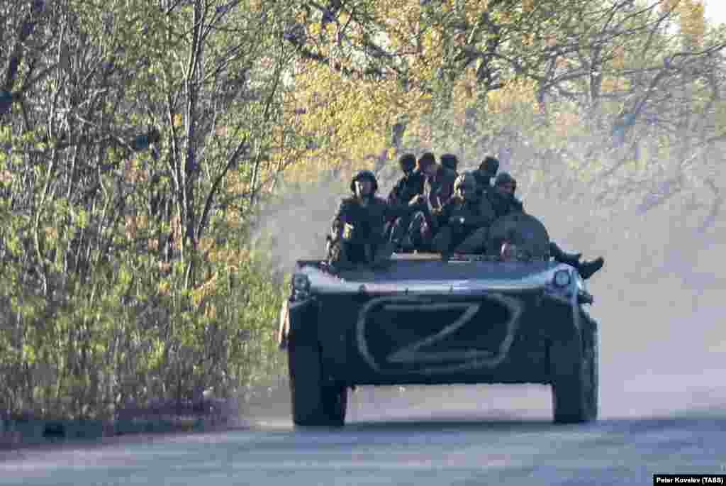 Kremlin-backed separatist fighters ride an armored vehicle in the Donetsk region on April 27. 