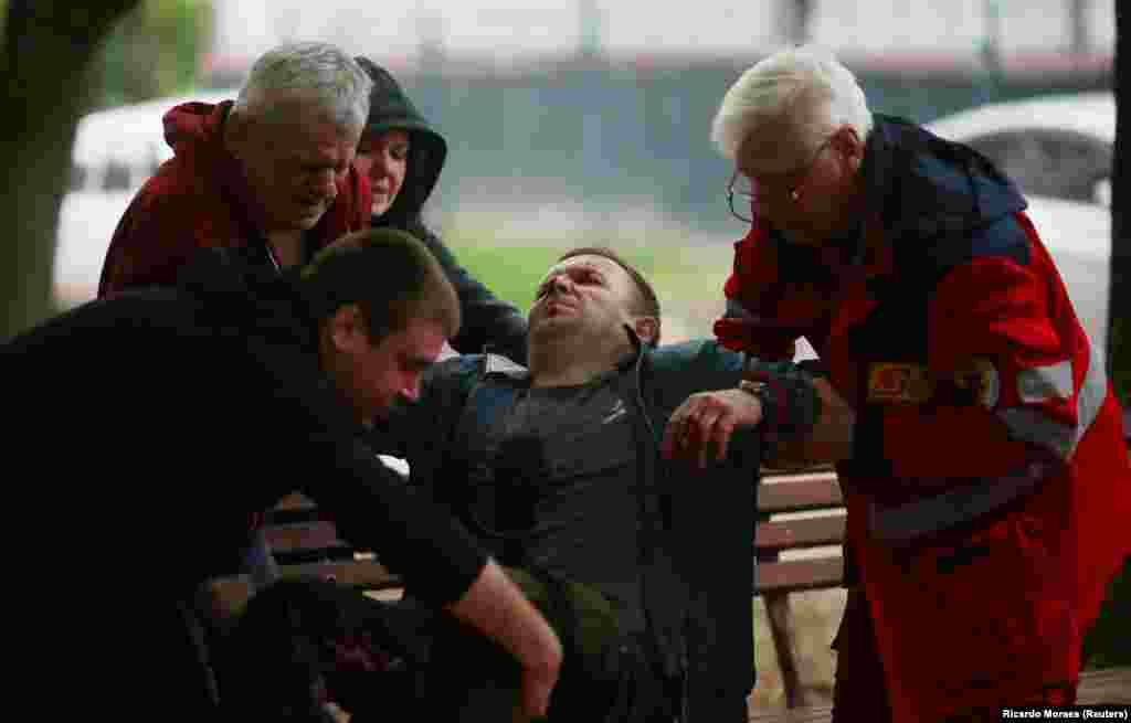 Medical workers help a man who was badly injured during shelling of Kharkiv on April 27. 