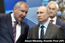 President Vladimir Putin (right) listens to then-Roskosmos head Dmitry Rogozin in April 2019.