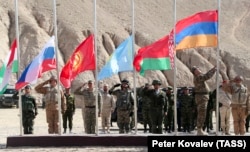 The national flags of Tajikistan, Russia, Kyrgyzstan, Kazakhstan, Belarus, and Armenia fly during a CSTO joint military exercise near the Tajik-Afghan border on October 18.
