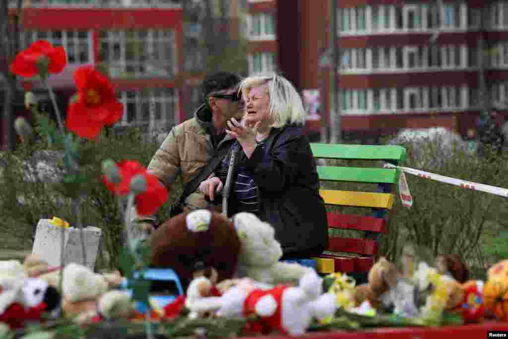 A woman reacts at the site of a deadly Russian missile strike on a residential area in Kryviy Rih that killed several children.