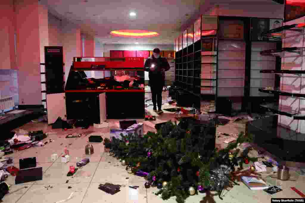 A toppled Christmas tree inside a looted store in Almaty. 