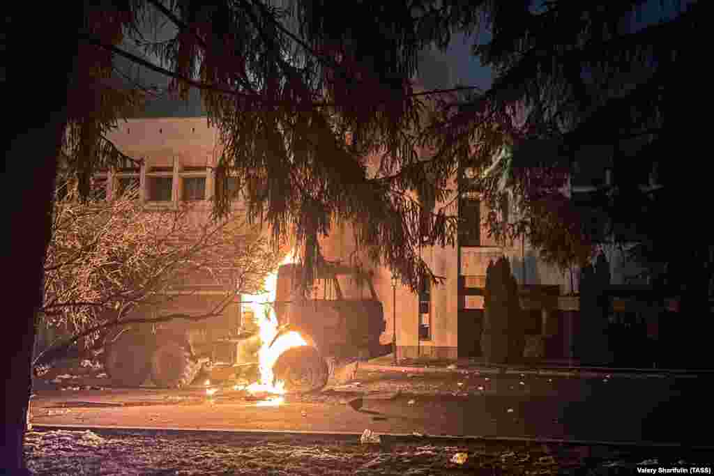 A truck burns next to the mayor's office in Almaty on the evening of January 5. There was violence and looting overnight in the city after massive anti-government protests swept much of the country. 