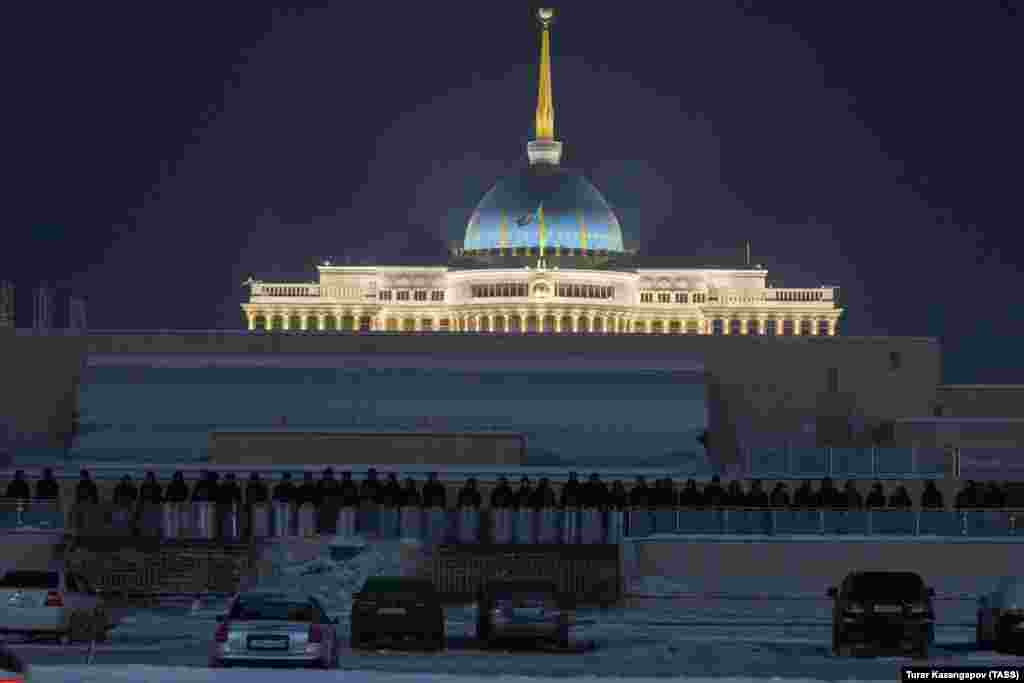 A wall of security forces lines the perimeter of the presidential palace in Nur-Sultan. The Kazakh capital city has been relatively quiet as deadly violence has swept Almaty. 
