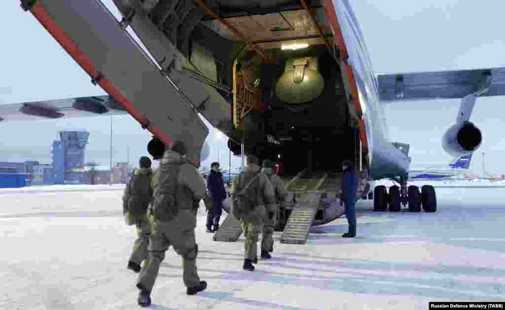 Russian airborne troops bound for Kazakhstan board a transport plane at Chkalovsky Airfield, northeast of Moscow, on January 6. A day earlier, Kazakh President Qasym-Zhomart Toqaev appealed for the intervention of the Collective Security Treaty Organization (CSTO), blaming foreign-trained "terrorist" gangs for the unrest sweeping his country.