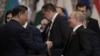 Russian President Vladimir Putin (right) shakes hands with Chinese President Xi Jinping at a Shanghai Cooperation Organization summit in Astana, Kazakhstan, on July 4.