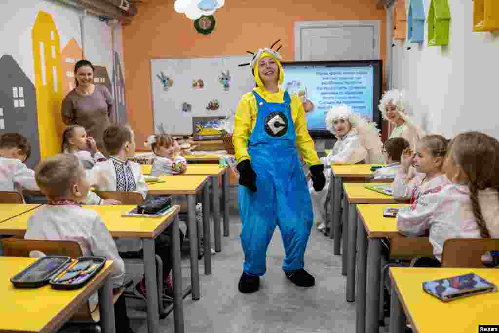 Pupils attend the first day of classes in a newly opened underground school that allows children to safely return to in-person studies in Kharkiv in war-torn Ukraine