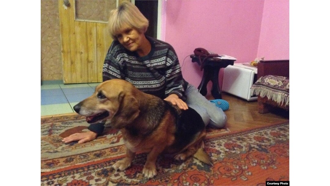 "I took them in because I knew that's what needed to be done," says Alyona Havryushyna, shown with Busya.