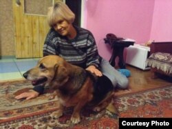 "I took them in because I knew that's what needed to be done," says Alyona Havryushyna, shown with Busya.