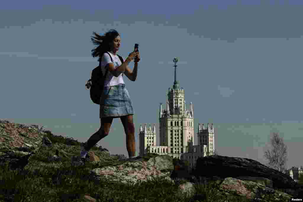 A woman walks in Zaryadye Park during a sunny day in Moscow.