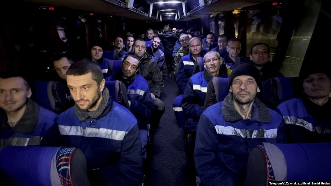 Ukrainian prisoners of war released as part of the latest swap with Russia ride a bus on December 30.