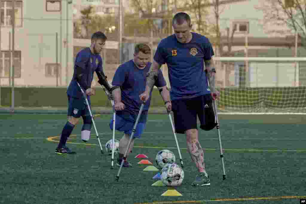 Amputee war veterans of the FC Nezlamni soccer club train at the stadium in Kharkiv, Ukraine.