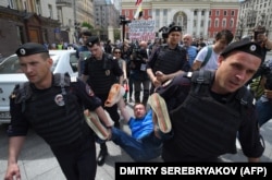 Russian riot police detain LGBT activist Nikolai Alekseyev during an unauthorized rally in central Moscow in May.