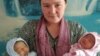 Farida Ghozieva with her newborn twin girls. She believes she also gave birth to a third child. 
