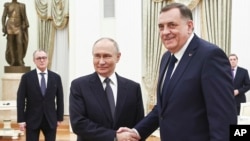 Bosnian Serb leader Milorad Dodik (right) is greeted by Russian President Vladimir Putin in Moscow on April 1. 