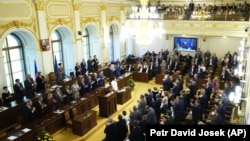 Czech lawmakers applaud Ukrainian President Volodymyr Zelenskiy's speech via video link in parliament in Prague in June.