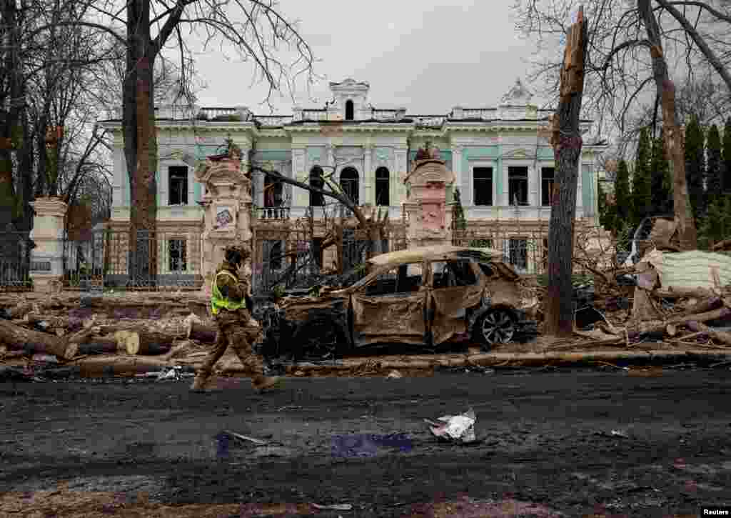 A Ukrainian soldier walks at the site of a Russian missile strike in Sumy, Ukraine.