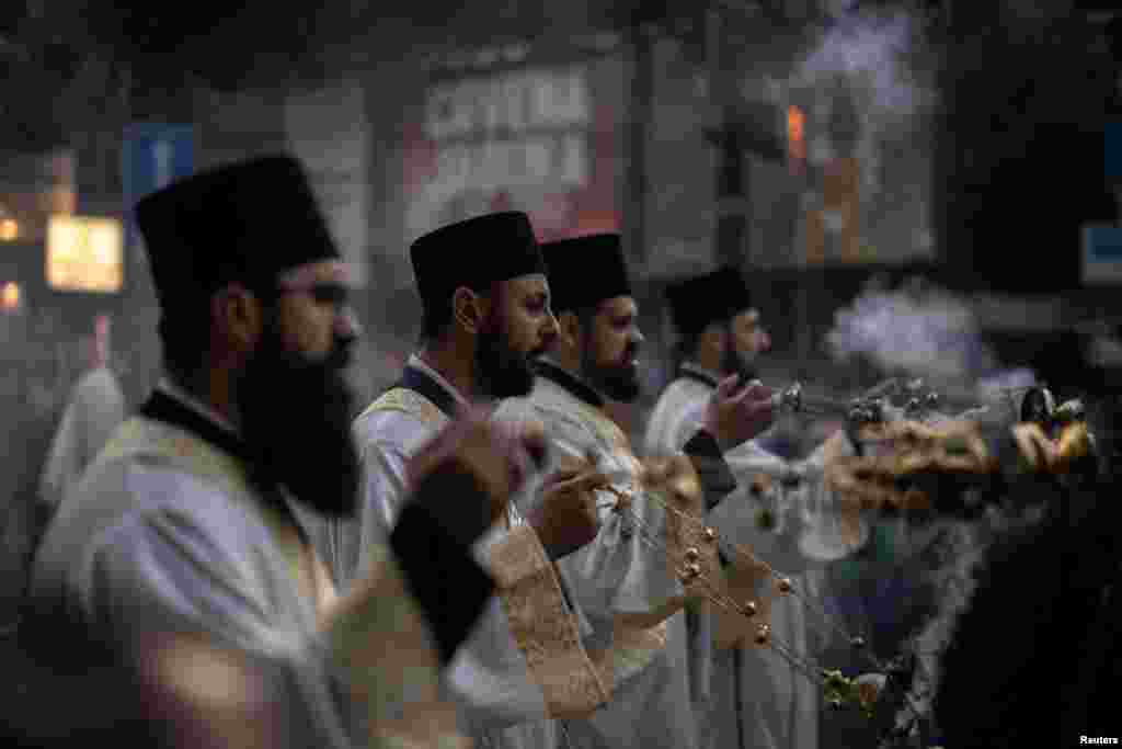Serbian Orthodox priests attend a religious procession in Belgrade to mark the Ascension of Jesus Christ in Belgrade on May 29.