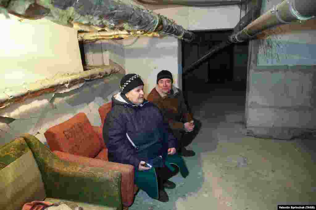 People sit in a bomb shelter in the separatist-controlled Petrovsky district of Donetsk on March 24.