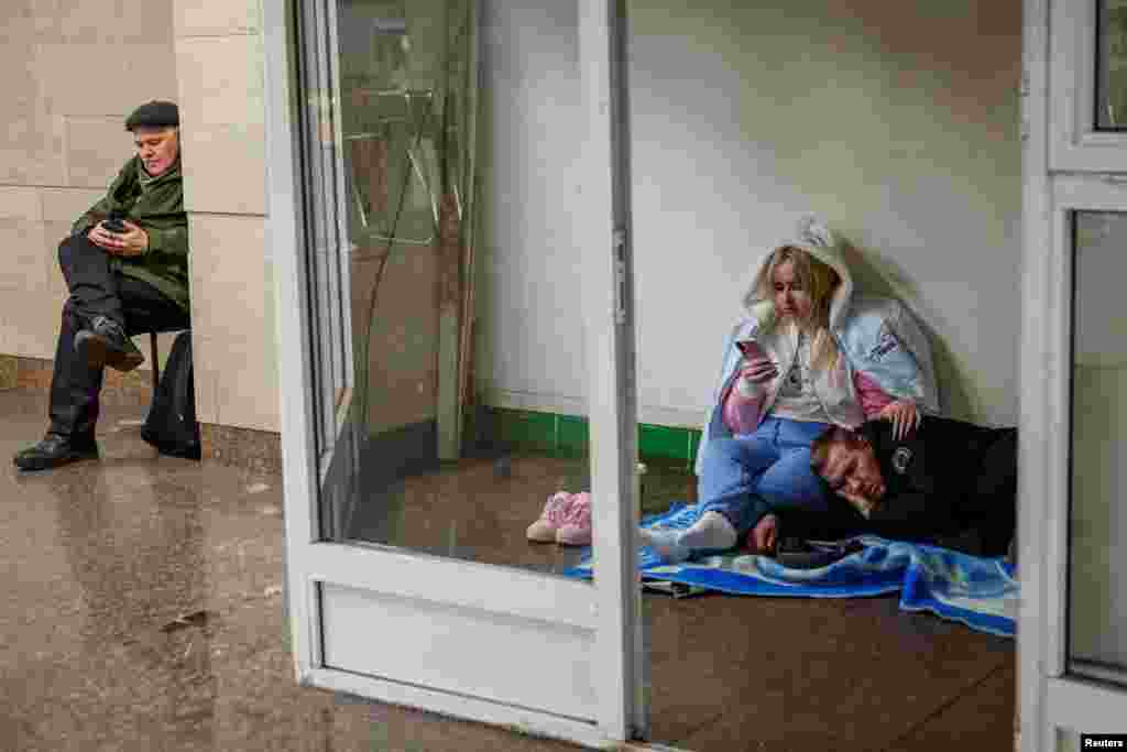 Ukrainians take shelter inside a subway station during a Russian military strike on Kyiv,