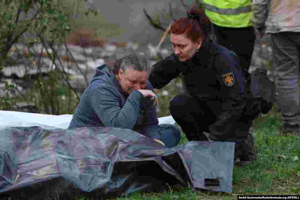 A resident grieves over the body of a victim of a Russian missile attack in Kyiv.