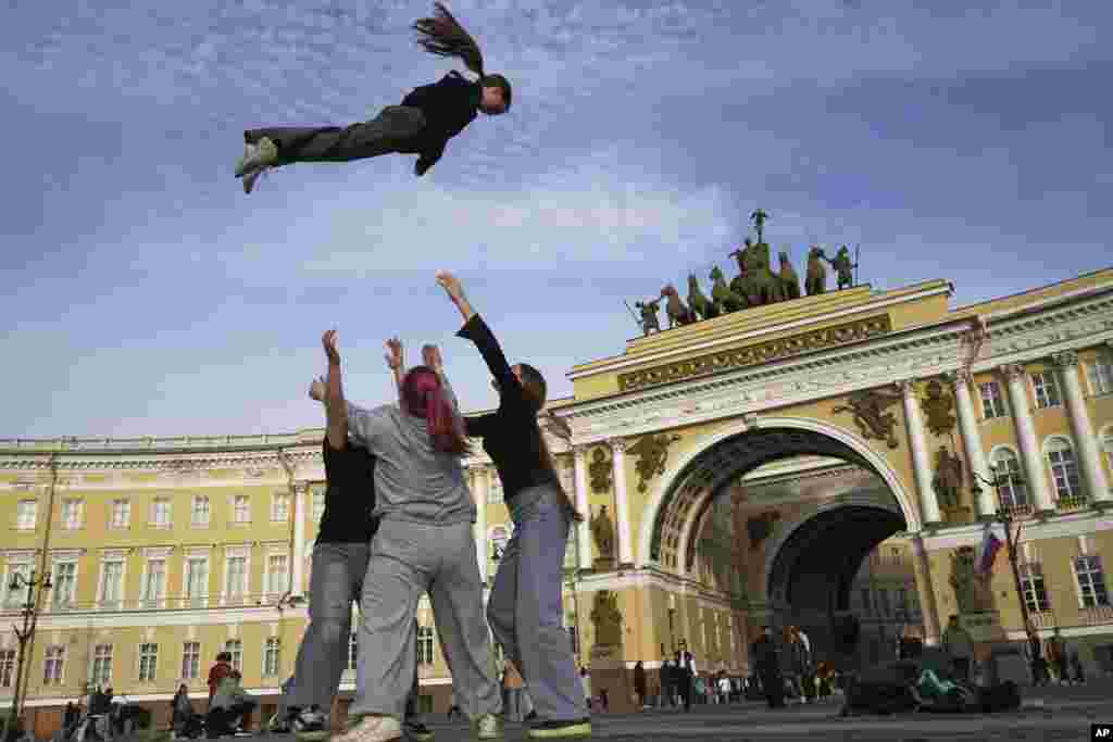 Girls practice their cheerleading skills outside Palace Square in St. Petersburg, Russia.