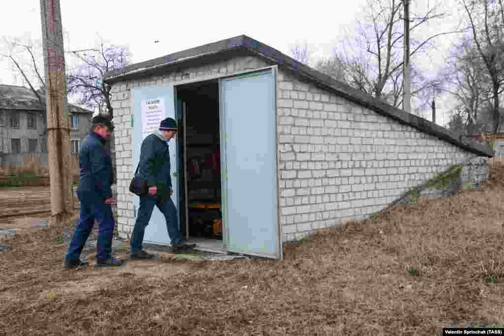 Men enter a bomb shelter at a tram depot in the Donetsk region on March 24 in an area controlled by separatists.&nbsp;