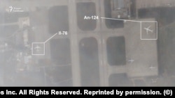 In this Planet Lab image obtained by RFE/RL's Russian Service, an Ilyushin Il-76 cargo jet and an Antonov An-124 are shown parked at the Hmeimim air base in Syria on December 6.