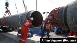 Workers are seen at the construction site of the Nord Stream 2 gas pipeline near the town of Kingisepp in Russia's Leningrad region.
