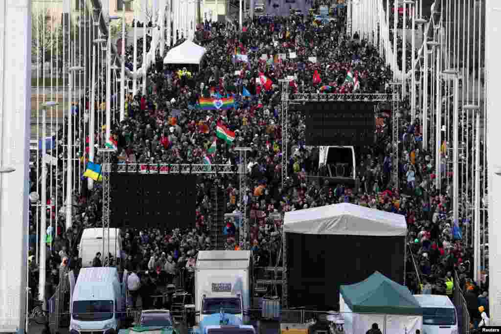 Protesters gather on Budapest's Elisabeth Bridge to demonstrate after the Hungarian parliament passed a law that will ban LGBTQ+ communities from holding their annual Pride march and which also introduces broader constraints on freedom of assembly.