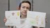 RFE/RL journalist Alsu Kurmasheva attends a court hearing in Kazan, Russia, on May 31, where she showed reporters children's drawings she has received from supporters.