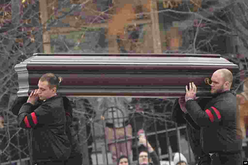 Navalny's coffin is carried to the church.