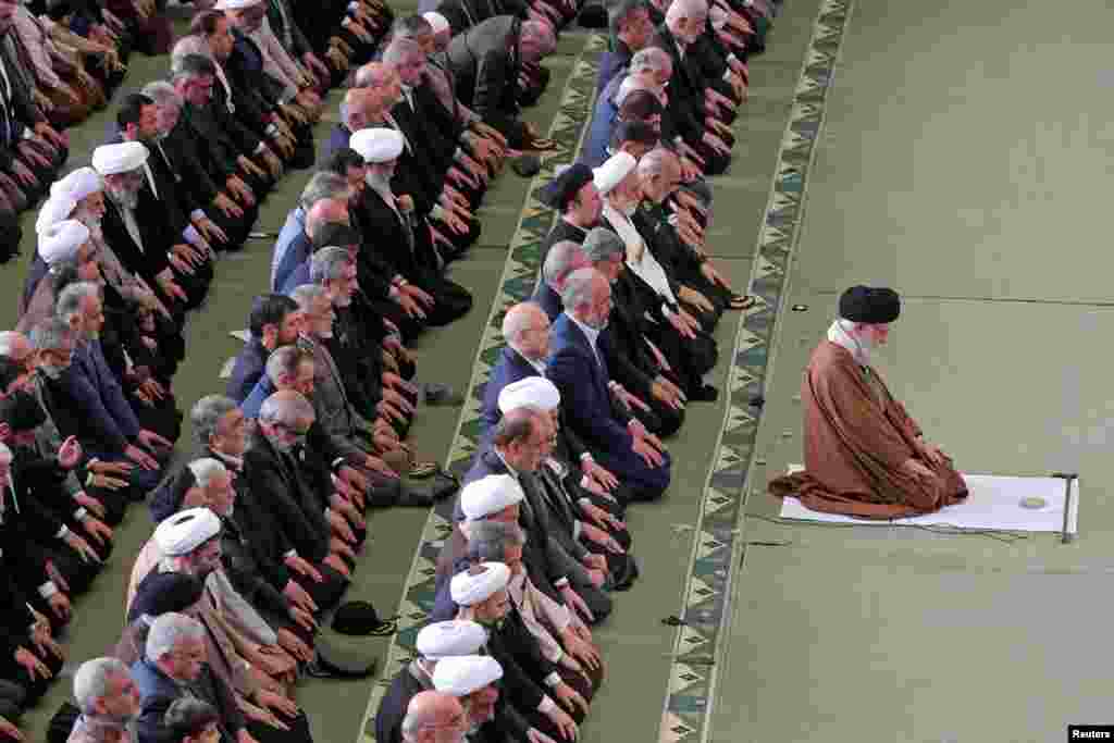 Iranian Supreme Leader Ayatollah Ali Khamenei (right) attends Eid al-Fitr prayers in Tehran.