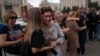Family members and supporters comfort one another as they gather on Kyiv's Maidan on July 29 to mark the first anniversary of the attack on a prison building in Olenivka in Russian-occupied Ukraine that killed dozens of Ukrainian military prisoners. 