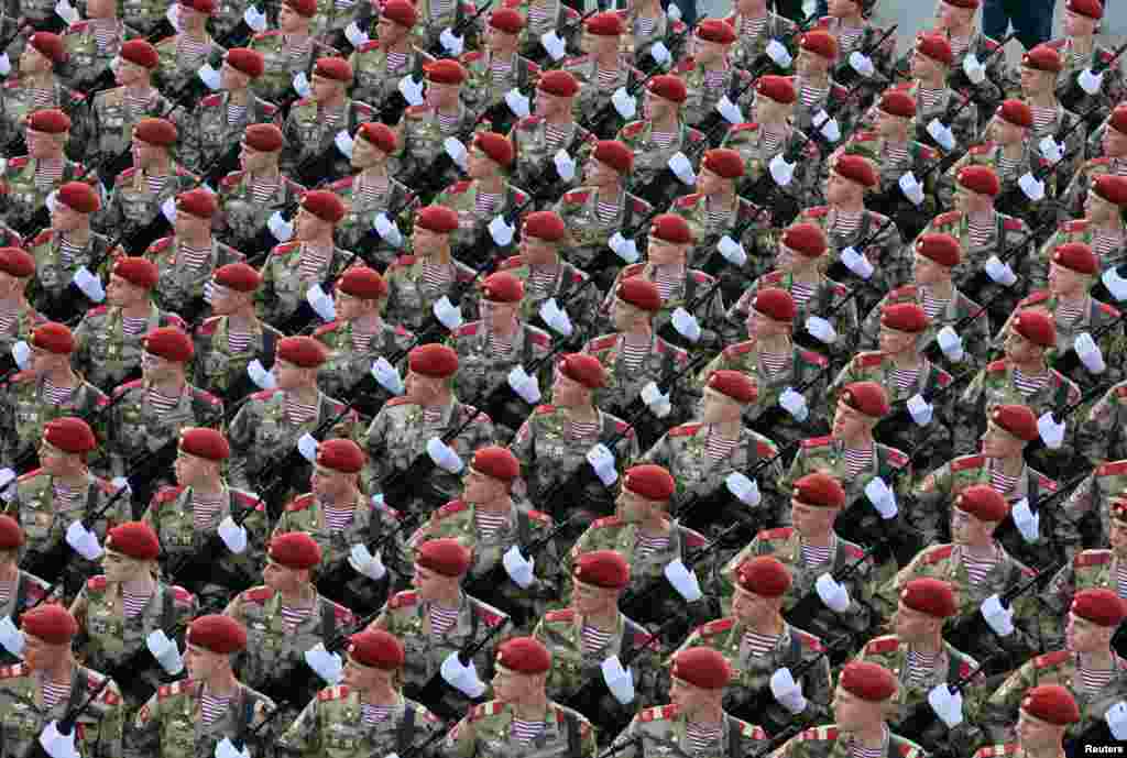 Russian service members march in columns on the day of a rehearsal for a military parade in Moscow to mark the defeat of Nazi Germany in World War II.