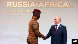 Burkina Faso interim leader Ibrahim Traore (left) shakes hands with Russian President Vladimir Putin during the Russia-Africa Summit in Russia last year. 