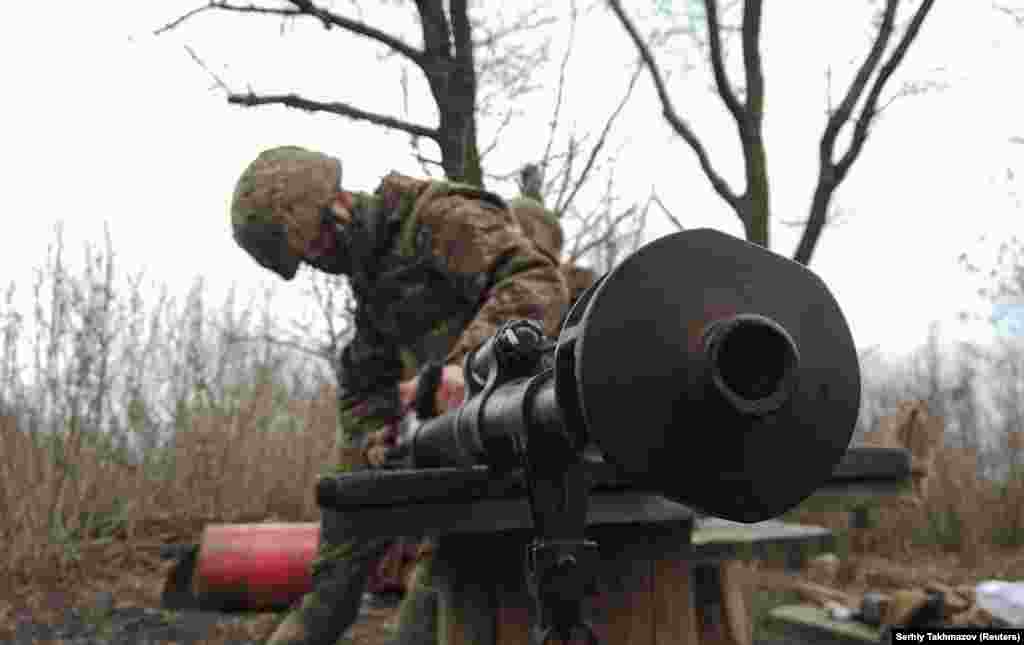 A Ukrainian soldier cleans a weapon.&nbsp;Observers point out that Russia has made large troop movements in the past in connection with regular military exercises. But some analysts say the scale of the Russian military equipment movements is&nbsp;far beyond normal.