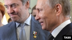 Russian President Vladimir Putin (right) presents a Hero of Labor award to Mariinsky Theater Director Valery Gergiev during a ceremony in St. Petersburg in May 2013.